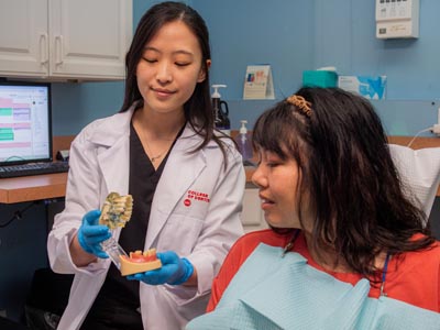 Dr. Shin showing how dental crowns can help restore a patient's smile