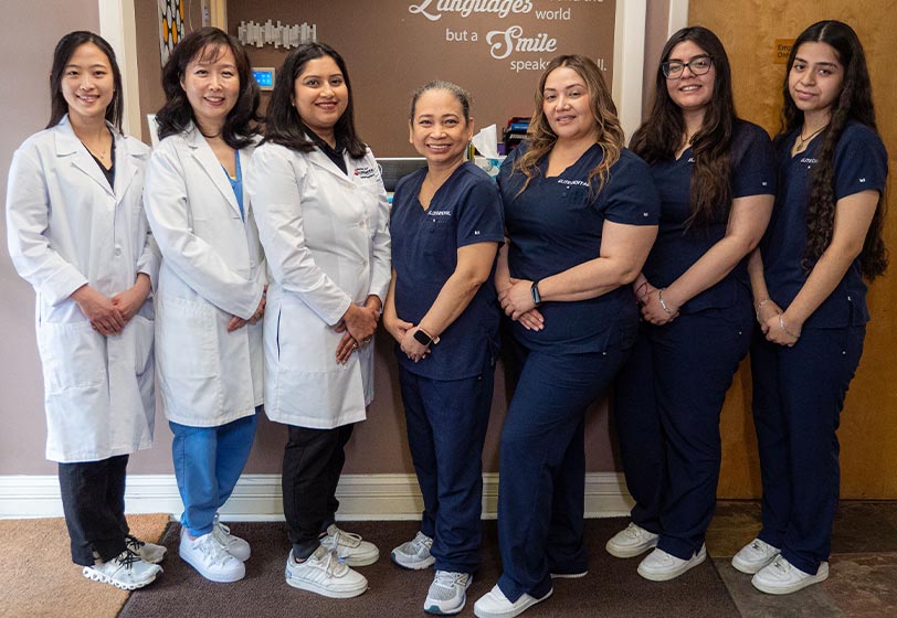 Elite Dental doctors and staff posing for a photo in the front office