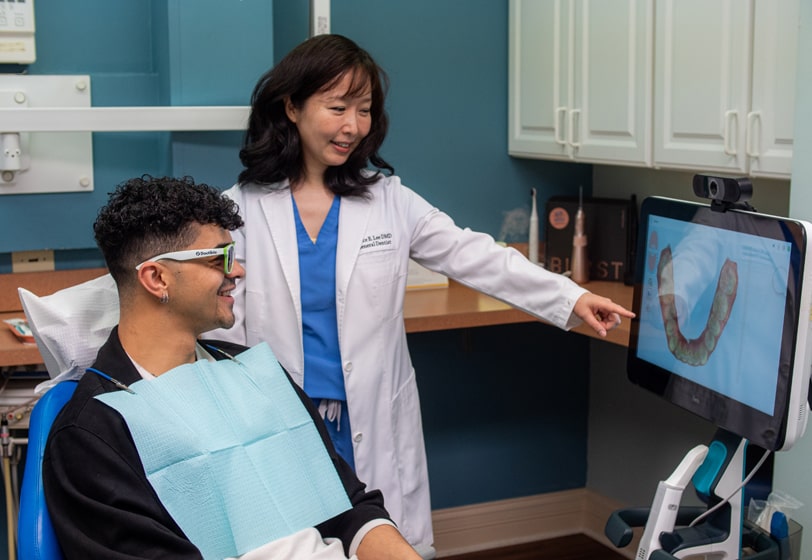 Chicago dentist Dr. Grace Lee discussing dental treatment options with a patient at Elite Dental